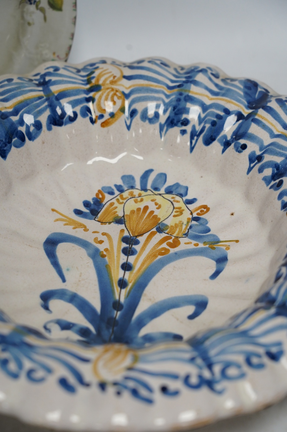 An Italian maiolica dish and a Masons Ironstone floral plate, largest 30cm in diameter (2). Condition - fair